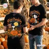 Two people wearing black shirts featuring Great Pumpkin 60th Anniversary graphics in a pumpkin patch.