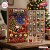 Front view of a Peanuts Snoopy 2026 advent calendar box alongside a plastic tray of holiday themed charms.
