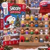 Front view of Peanuts Snoopy Christmas 2026 Advent Calendar box and twenty-four figurines on shelves.