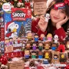 Front view of the Peanuts Snoopy Christmas 2026 Advent Calendar box alongside displayed character figurines.