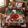 Top view of a Peanuts Snoopy Christmas quilt bedding set featuring holiday graphics on a made bed.