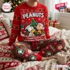 Front view of a red Peanuts Snoopy Christmas sweater and matching patterned jogger pants.