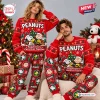 Front view of a couple wearing matching red holiday sweaters and plaid jogger pants set.