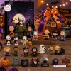 Collection of Peanuts Snoopy Halloween figurines displayed with a themed calendar.