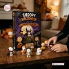 Front view of Peanuts Snoopy Halloween 2026 Advent Calendar box with miniature figurines arranged on table.