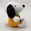 Side view of a white stuffed animal toy wearing an orange pumpkin body.