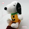 Side view of Peanuts Snoopy Halloween Pumpkin Plush Doll wearing an orange pumpkin costume.