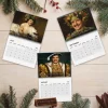 Top-down view of three Pedro Pascal Renaissance Masterpieces 2027 Wall Calendar pages on a wooden surface with pine branches.