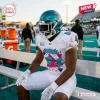 Football player wearing the Personalized Coastal Carolina Chanticleers 2026 Football Jersey while sitting on a bench.