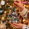 Close-up of hands holding a Philadelphia Eagles Nick Foles Philly Special Ornament on a Christmas tree.