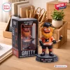 Front view of Philadelphia Flyers Gritty 60th Anniversary Vinyl Figure standing beside its branded box on a desk.