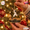 Close-up of hands hanging a Pittsburgh Pirates Bill Mazeroski Christmas Ornament on a tree.