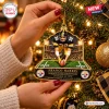 Close-up of hands holding a football player Christmas ornament depicting a historic play.