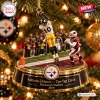 Close-up of a Pittsburgh Steelers Santonio Holmes Toe-Tap Catch Christmas Ornament hanging on a tree.