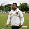 Man wearing PNG Chiefs Limited Edition White Hoodie with tribal patterns on a rugby field.