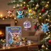 Front view of a boxed advent calendar and hanging holiday ornaments featuring cartoon creatures on a Christmas tree.