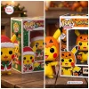 Side-by-side view showing a Christmas and Halloween themed Pokémon Pikachu Christmas Vinyl Figure in packaging.