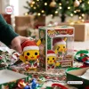 Hand holding a Pokémon Pikachu Christmas vinyl figure next to its decorated box in a holiday setting.