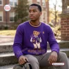 Front view of a purple sweatshirt featuring a bear graphic and Omega Psi Phi lettering worn outdoors.