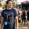 Man wearing the Powderfinger Rock Band 2027 Tour Limited Edition Shirt at an outdoor concert.