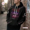 Front view of a Queens Of The Stone Age Tour Black Hoodie worn against a brick wall.