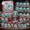Front view of the Racing Miku Advent Calendar 2026 packaging alongside numerous turquoise-haired anime keychains.
