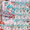 Front view of the Racing Miku Advent Calendar 2026 box alongside twenty-four numbered anime figure keychains.