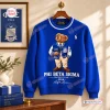 Front view of a blue Ralph Lauren x Phi Beta Sigma sweatshirt hanging on a wooden hanger with a teddy bear graphic.