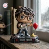 Front view of Richie Tozier Funko Pop Figure holding a flashlight near a red balloon and paper boat.