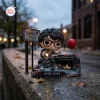 Front view of Richie Tozier Funko Pop Figure outdoors near a Derry Maine sign and red balloon.