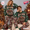 Front view of a couple wearing Riley Green Christmas ugly sweater and jogger pants set.