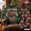 Front view of green ugly Christmas sweater and patterned jogger pants set on an armchair.