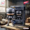 Front view of the Robocop OCP Police 001 40th Anniversary Figure standing beside its themed display box on a desk.