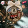 Front view of a clear spherical Route 66 100th Anniversary Christmas Ornament containing miniature road trip scenes.