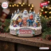 Front view of Rudolph The Red-Nosed Reindeer Christmas figurine ornament on a wooden surface with pine branches.