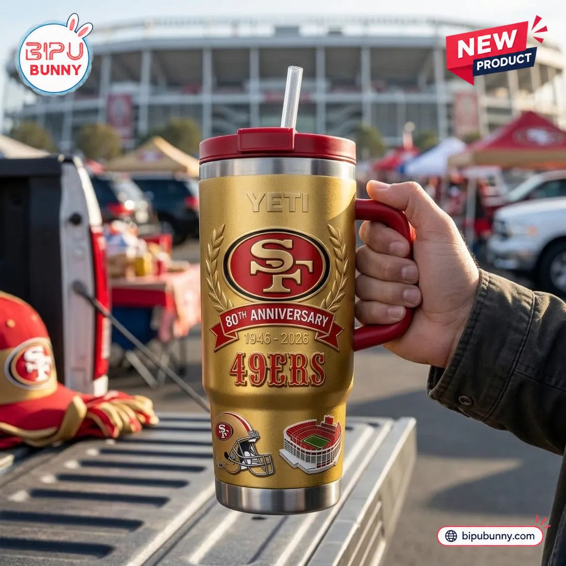 Handheld tailgate view of the San Francisco 49ers 80th Anniversary Tumbler Cup on a pickup truck bed beside a 49ers hat and gloves