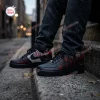Lifestyle view of Saw Horror Movie Spiral Air Force 1 Sneakers worn on urban concrete steps.