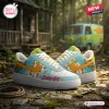 Side view of Scooby-Doo Blue Air Force Low-Top Sneakers featuring cartoon character graphics and a yellow swoosh.