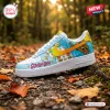 Side view of Scooby-Doo Blue Air Force Low-Top Sneakers resting on a bed of autumn leaves.