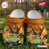 Front view of Scooby Doo Halloween Crocs clogs shoes featuring a spooky pumpkin and van graphic on orange.