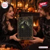A man and woman holding the SCP-049 Gothic Plague Doctor Advent Calendar in a warmly lit room.