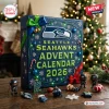 Front view of Seattle Seahawks 2026 Advent Calendar box decorated with ornaments and team logo on wooden table.