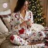 Woman wearing Snoopy Christmas Pajamas Set holding a mug in a holiday bedroom setting.