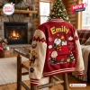 Back view of the Snoopy Happiness Is A Warm Hug Varsity Jacket featuring holiday graphics in a cozy room.