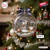 Closeup of Snoopy Happy Holidays Snow Globe Ornament hanging on a Christmas tree with baseball theme.