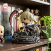 Side view of a Soul Eater Maka Albarn collectible figure holding a large scythe on a detailed graveyard base.