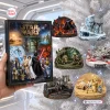 Hand holding Star Wars 24 Planet Adventures Advent Calendar next to hanging planet ornaments on a tree.