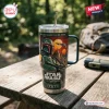 Front view of a Star Wars Boba Fett 50th Anniversary Tumbler with handle on a wooden picnic table outdoors.