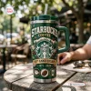 Front view of the Starbucks 55th Anniversary 1971-2026 Tumbler on a wooden table outdoors.
