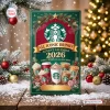 Front view of Starbucks Holiday & Iconic Drinks Advent Calendar 2026 box with festive coffee cups on a snowy wooden surface.